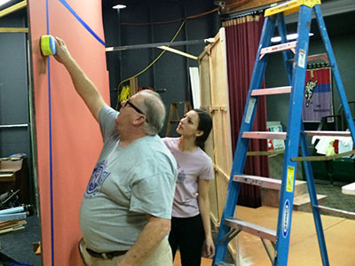 Volunteers paint backdrops for a Theater Bartlesville production